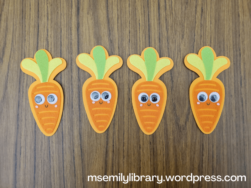 Felt pieces of carrots with googly eyes and smiles