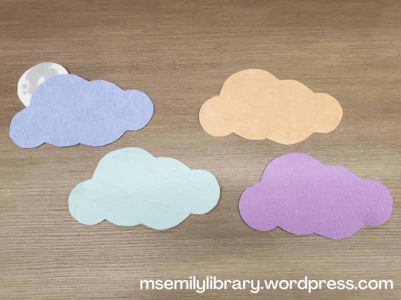 Find the Moon flannel, with four clouds (blue, peach, lilac, and mint green) with a white and gray moon peeking from behind the blue one.