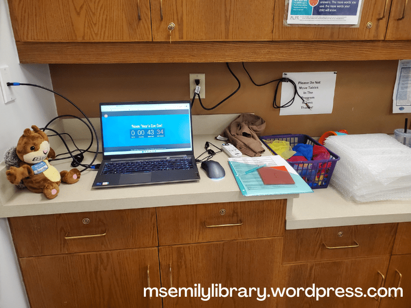 Set up showing laptop, scaredy squirrel puppet, scarves, bubble wrap, and bubble machine