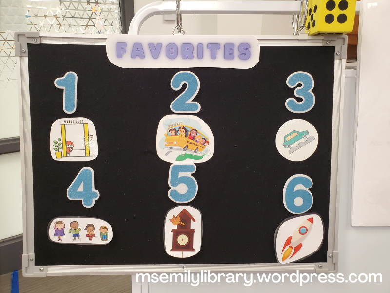 Flannelboard marked "Favorites" at the top, then numbered 1-6. Icons are: 1 girl peeking from open elevator 2 kids on schoolbus, 3 car on a bumpy road 4 four kids, touching their head shoulders, knees, and toes 5 cuckoo clock with bird popping out 6 rocket ship