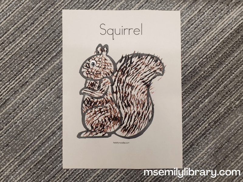 coloring page of a squirrel with brown fur painted on with a fork.