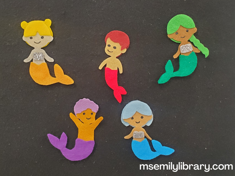 flannel showing five merkids with different colored hair and tails: yellow mermaid (in funbuns), red merboy with straight hair, green mergirl with a braid, blue mergirl with a bob, and purple merboy with curly hair.