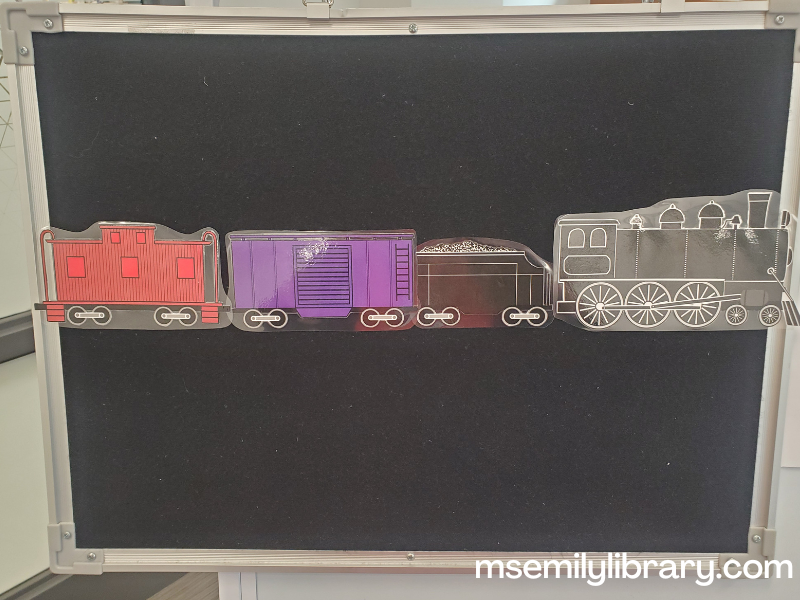 train flannel made of printed and laminated images of a short train consisting of a black engine and coal car, a purple box car, and a red caboose.