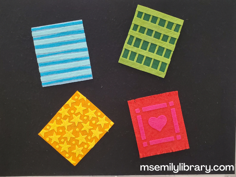 flannel showing four blankets - a blue one with lighter blue stripes, a green one with lighter green checks, a yellowy-orange one with bright yellow stars, and a red one with a dark pink heart.