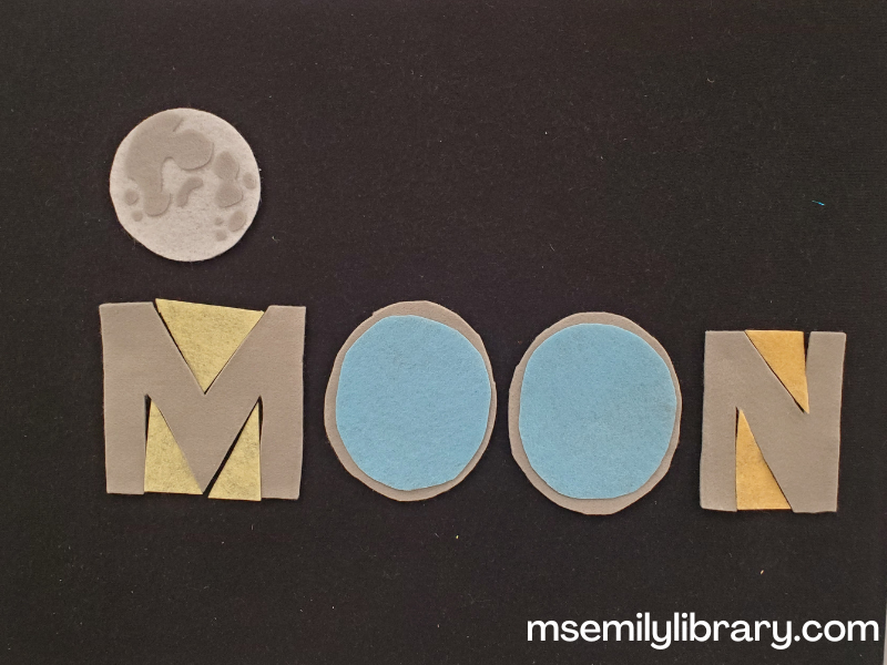 Moon word flannel: the word moon is spelled in capital letters in grey felt, with tan triangles in the spaces of the M and N, and blue circles covering the Os. A realistic looking felt moon is above the word.