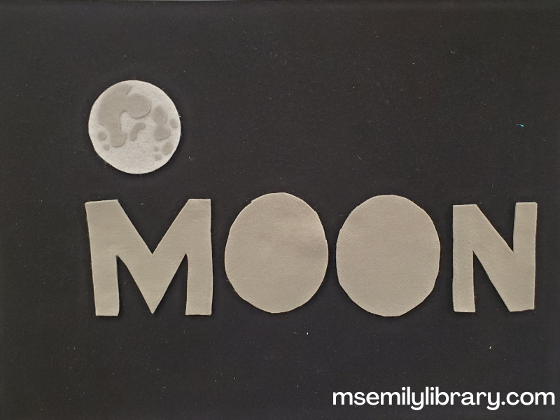 Moon word flannel: the word moon is spelled in capital letters in grey felt, with a realistic looking felt moon above it.