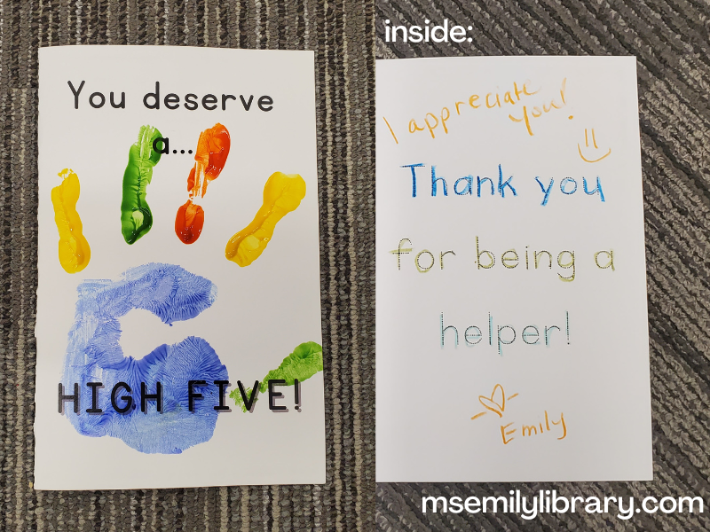 Craft greeting card showing the front reading "You Deserve a High Five!" with a painted handprint, and the inside saying "Thank You for being a helper"