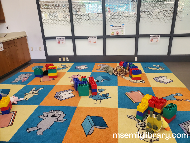blocks and puppets on a rug