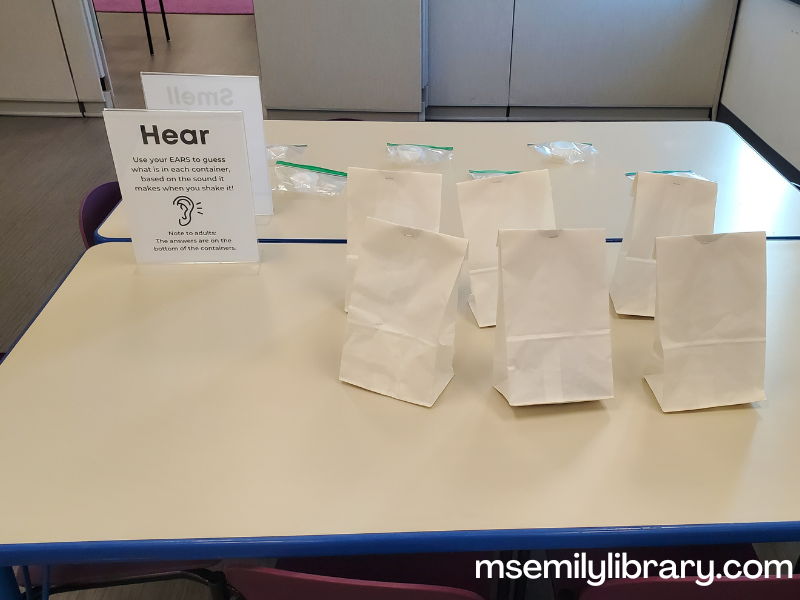 hear station, with a sign explaining and six white paper bags that have been stapled shut