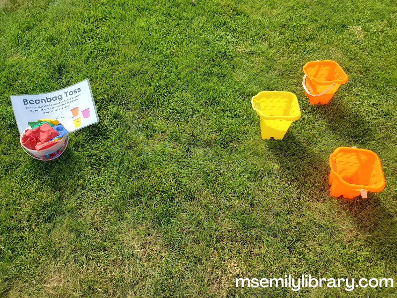 small sand buckets sitting opposite a bucket of beanbags