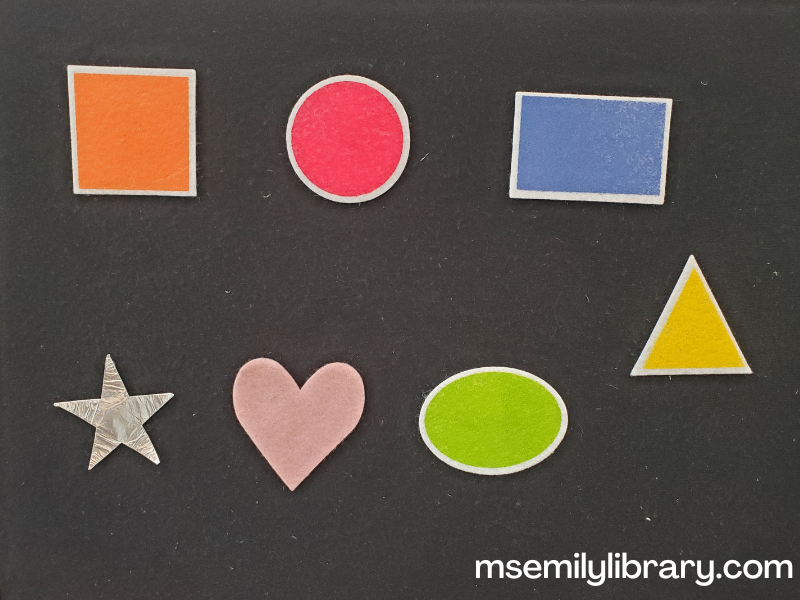 colors and shapes flannel, with an orange square, red circle, blue rectangle, yellow triangle, green oval, pink heart, and silver star