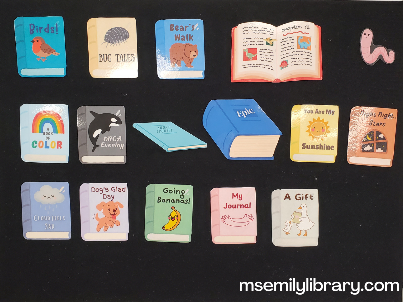 Library cheer flannel, with printed and laminated book covers representing each book mentioned in the cheer, for a total of 15.  A small pink earthworm is off to the side.